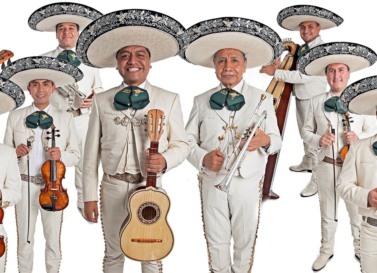 Men posing with their instruments in full mariachi garb.